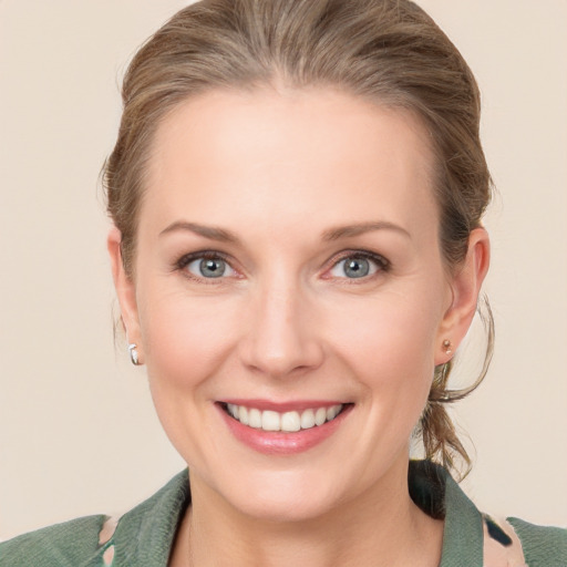 Joyful white young-adult female with medium  brown hair and blue eyes