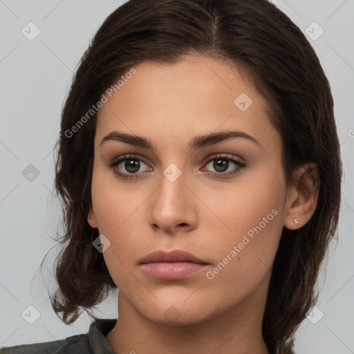 Neutral white young-adult female with long  brown hair and brown eyes