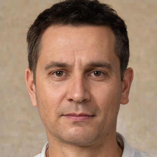 Joyful white adult male with short  brown hair and brown eyes