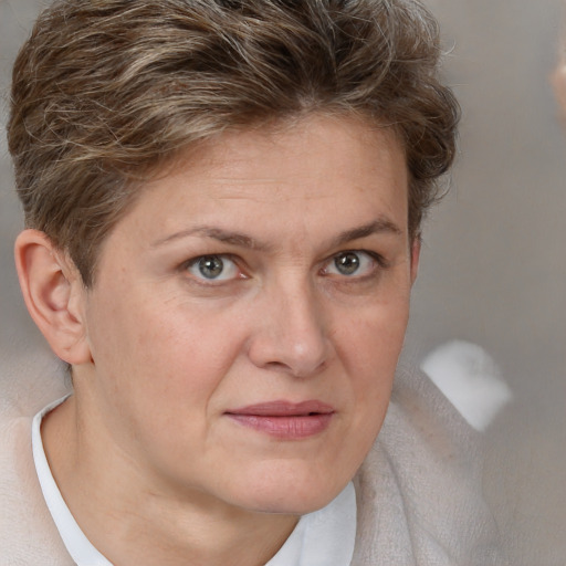 Joyful white adult female with short  brown hair and brown eyes