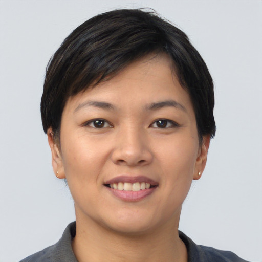 Joyful asian young-adult female with short  black hair and brown eyes
