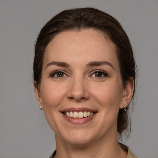 Joyful white young-adult female with medium  brown hair and brown eyes