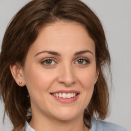 Joyful white young-adult female with medium  brown hair and green eyes