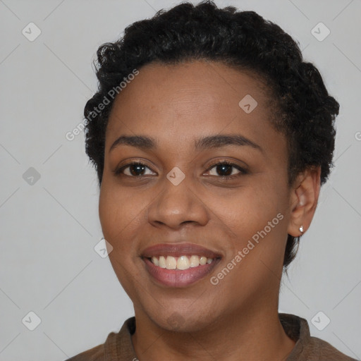 Joyful black young-adult female with short  black hair and brown eyes