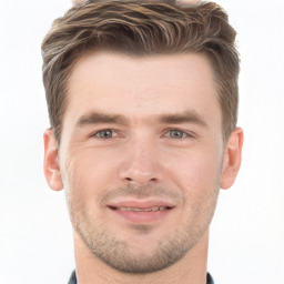 Joyful white young-adult male with short  brown hair and grey eyes