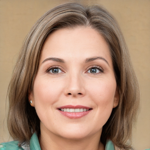 Joyful white young-adult female with medium  brown hair and green eyes