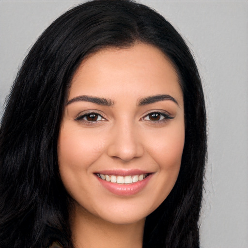 Joyful white young-adult female with long  black hair and brown eyes