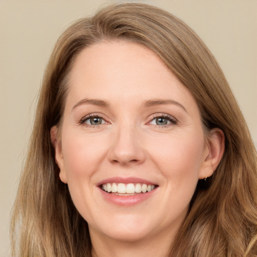 Joyful white young-adult female with long  brown hair and green eyes