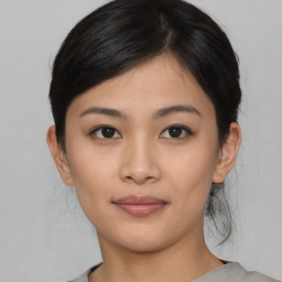 Joyful asian young-adult female with medium  black hair and brown eyes