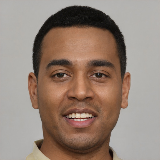 Joyful black young-adult male with short  black hair and brown eyes