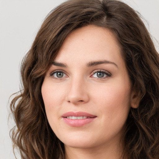 Joyful white young-adult female with long  brown hair and green eyes