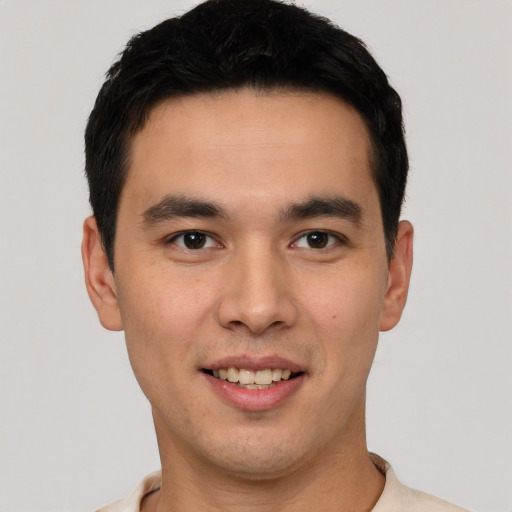 Joyful latino young-adult male with short  black hair and brown eyes