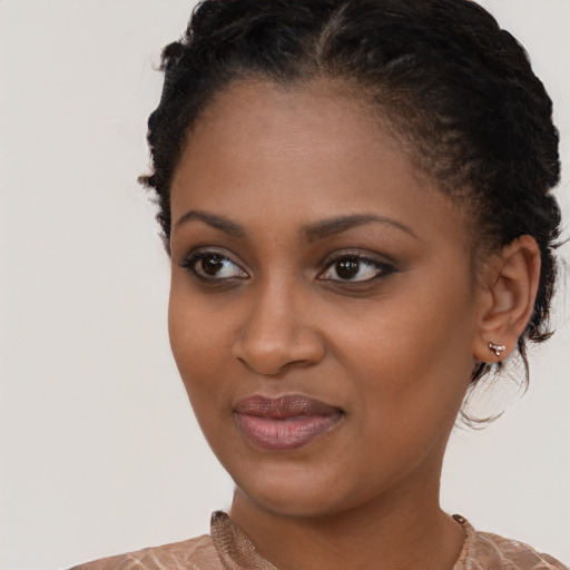 Joyful black young-adult female with medium  brown hair and brown eyes