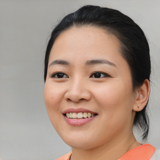 Joyful asian young-adult female with medium  black hair and brown eyes
