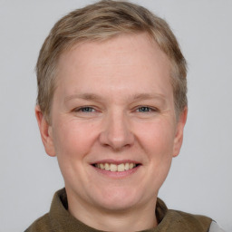 Joyful white adult male with short  brown hair and grey eyes