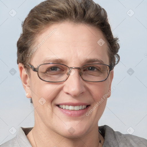 Joyful white adult female with short  brown hair and blue eyes