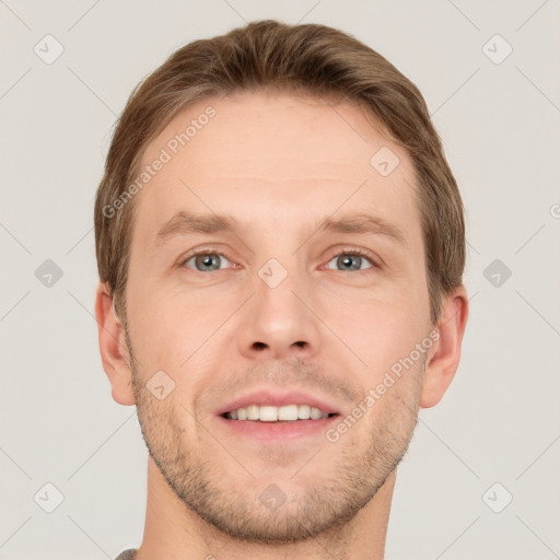 Joyful white young-adult male with short  brown hair and grey eyes