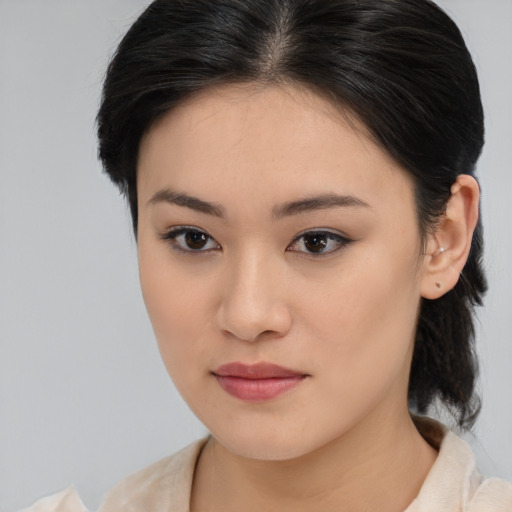 Joyful asian young-adult female with medium  brown hair and brown eyes