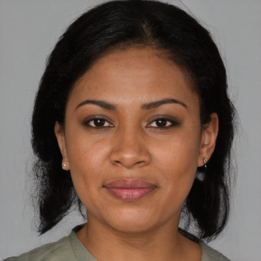 Joyful black young-adult female with medium  brown hair and brown eyes