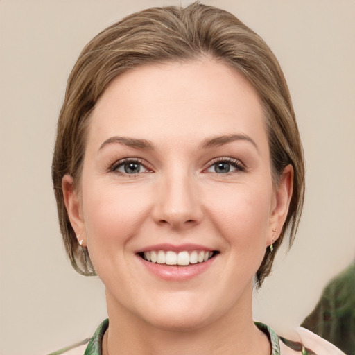 Joyful white young-adult female with medium  brown hair and green eyes