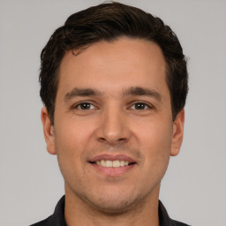 Joyful white young-adult male with short  brown hair and brown eyes