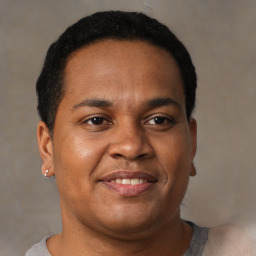 Joyful latino young-adult male with short  brown hair and brown eyes