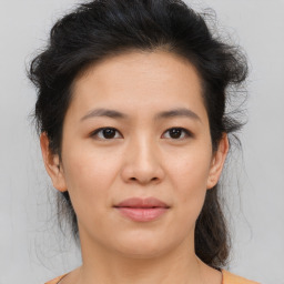 Joyful asian young-adult female with medium  brown hair and brown eyes