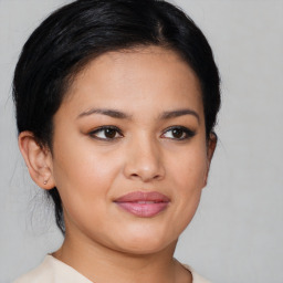 Joyful latino young-adult female with medium  brown hair and brown eyes