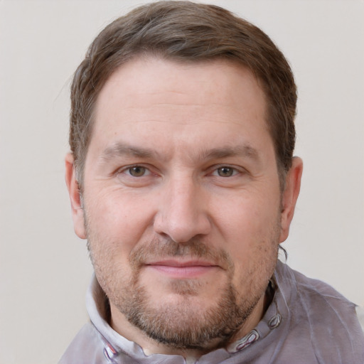 Joyful white adult male with short  brown hair and grey eyes