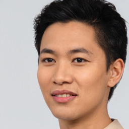 Joyful asian young-adult male with short  black hair and brown eyes