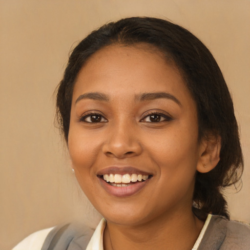 Joyful latino young-adult female with medium  brown hair and brown eyes