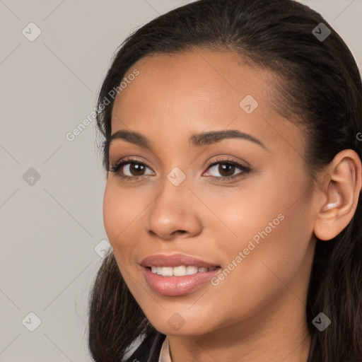 Joyful latino young-adult female with long  brown hair and brown eyes