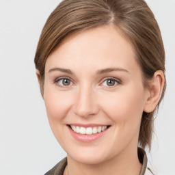 Joyful white young-adult female with medium  brown hair and grey eyes