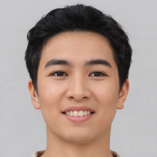 Joyful asian young-adult male with short  black hair and brown eyes