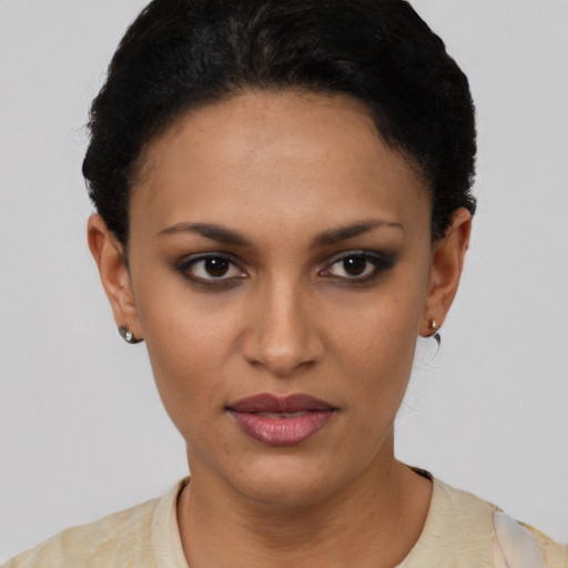 Joyful latino young-adult female with short  brown hair and brown eyes