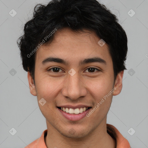 Joyful latino young-adult male with short  brown hair and brown eyes