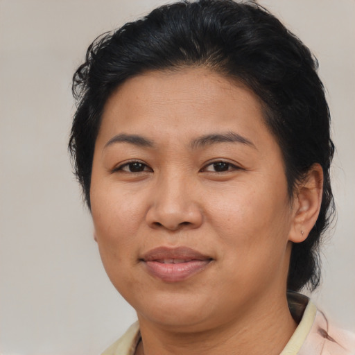 Joyful asian adult female with medium  brown hair and brown eyes