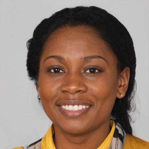 Joyful latino adult female with medium  black hair and brown eyes