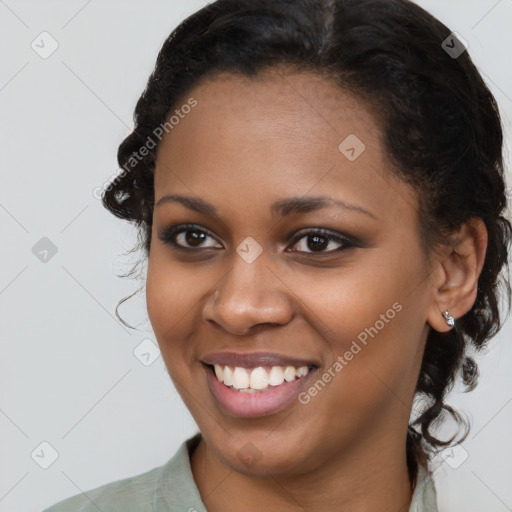 Joyful black young-adult female with medium  brown hair and brown eyes