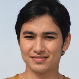 Joyful asian young-adult male with short  brown hair and brown eyes