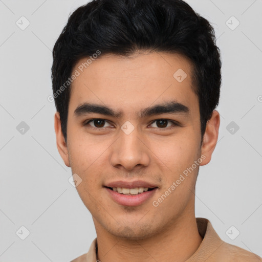 Joyful latino young-adult male with short  brown hair and brown eyes