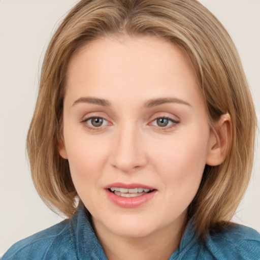 Joyful white young-adult female with medium  brown hair and blue eyes