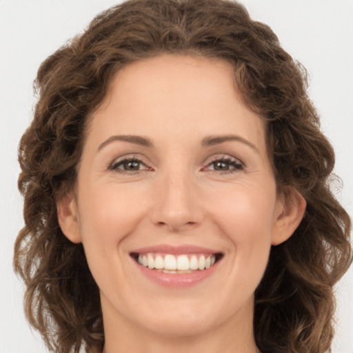 Joyful white young-adult female with long  brown hair and green eyes