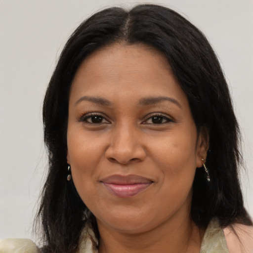 Joyful latino adult female with long  brown hair and brown eyes