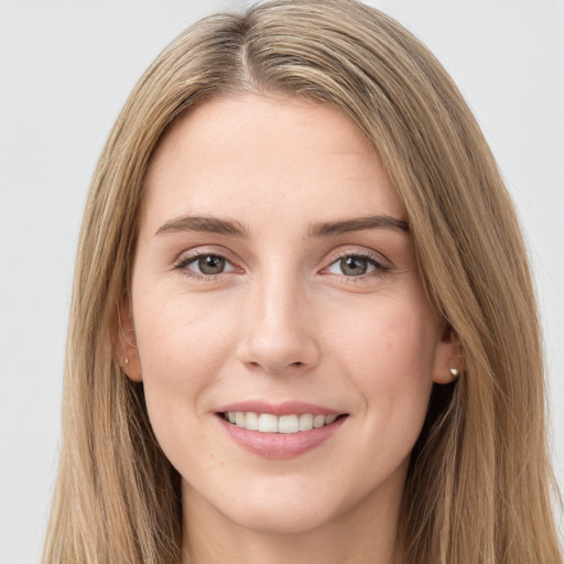 Joyful white young-adult female with long  brown hair and brown eyes