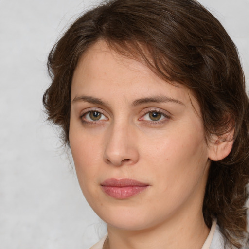 Joyful white young-adult female with medium  brown hair and green eyes