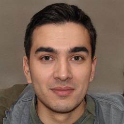 Joyful white young-adult male with short  black hair and brown eyes