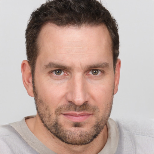 Joyful white adult male with short  brown hair and brown eyes