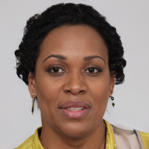 Joyful black adult female with short  brown hair and brown eyes
