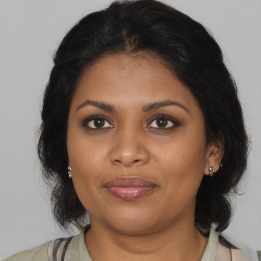 Joyful black young-adult female with medium  brown hair and brown eyes